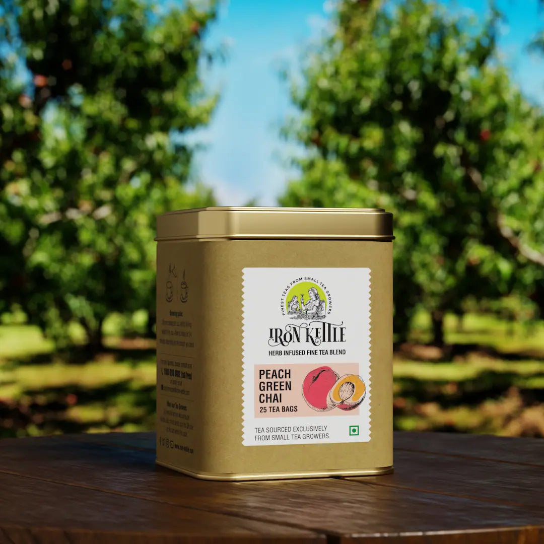 Peach Green Chai tea tin placed in a lush orchard setting, emphasizing the natural, fruity ingredients of this refreshing green tea blend.